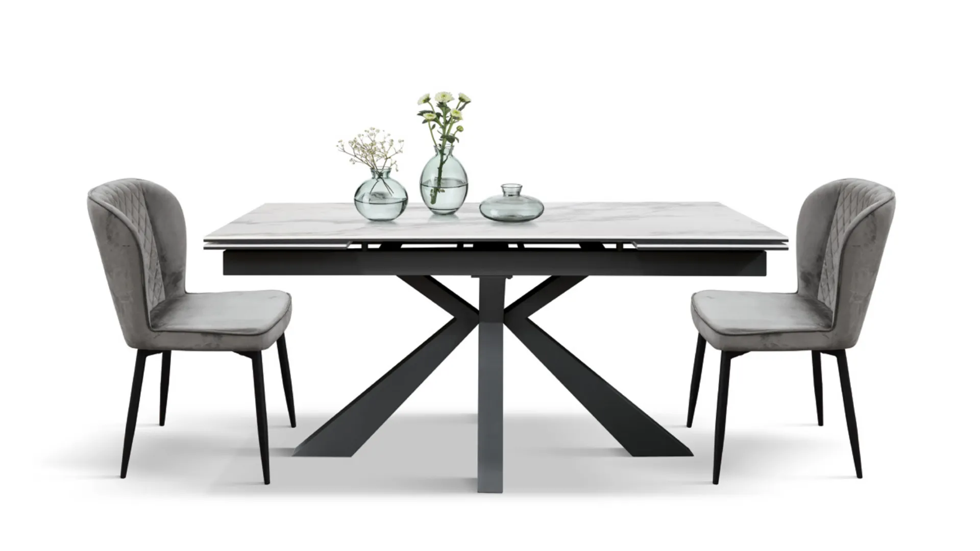 Extendable table with top in white statuary finish and base in anthracite-colored metal.