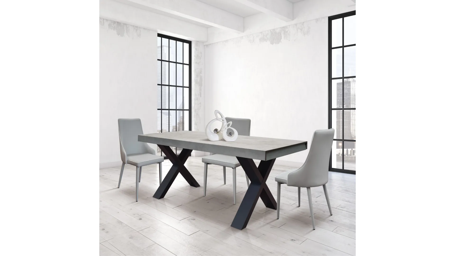 Extendable laminate table with X-shaped design legs and two lateral extensions.