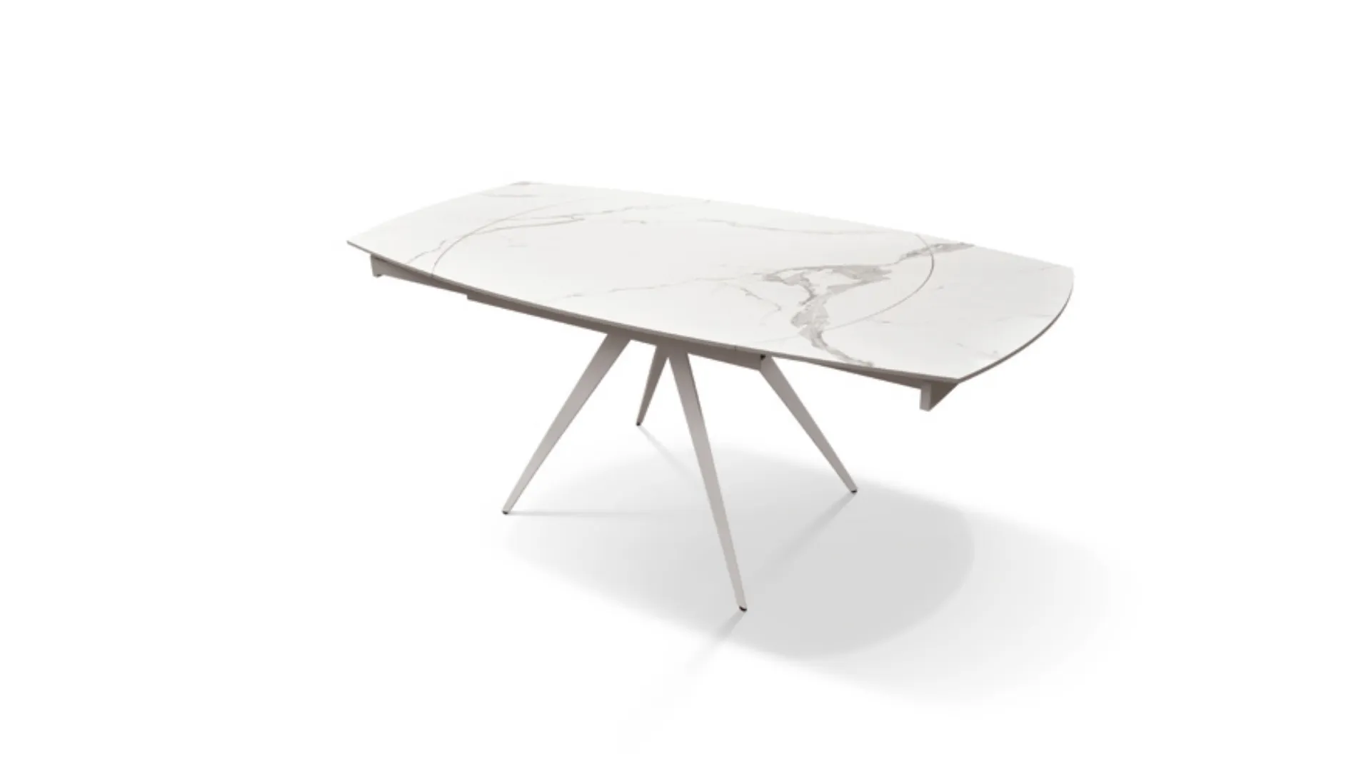 Extendable shaped table with ceramic top and central metal base in white finish.