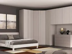 Double bedroom with spacious corner walk-in wardrobe, chest of drawers, bedside tables, and Nuvola bed.