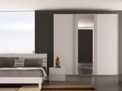 Modern room with a three-door wardrobe and mirrors, comfortable bed model Cloud.