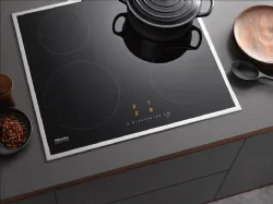 Miele Induction Hob with 4 cooking zones of different sizes.