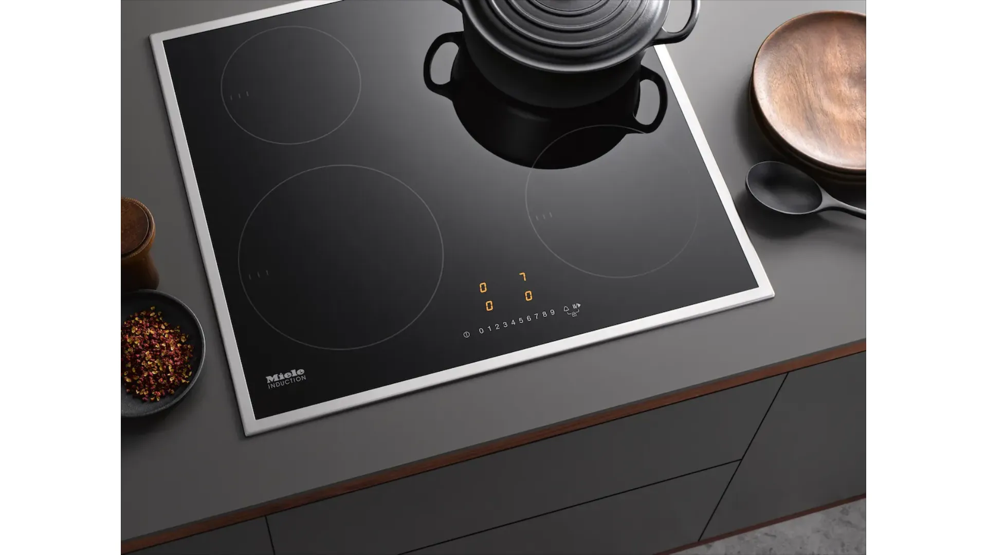Miele Induction Hob with 4 cooking zones of different sizes.