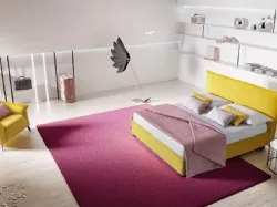 Silene bed with linear headboard softened by light lateral folds