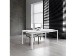 Extendable table with four metal legs, rustic oak top, and side extension.